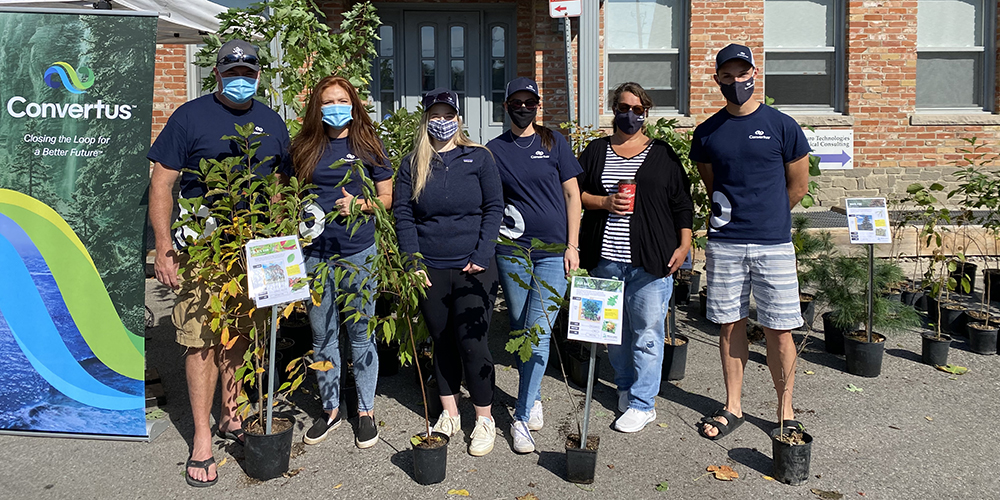 Convertus staff giving out trees