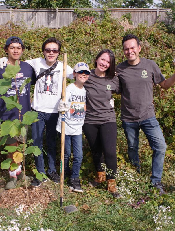 A group from GreenTech Painting plants trees