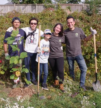 A group from GreenTech Painting plants trees